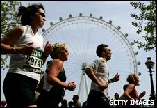 Runners pass the London eye